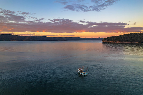 Peaceful sunrise over the bay with boats