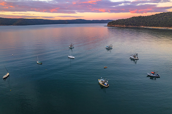 Peaceful sunrise over the bay with boats