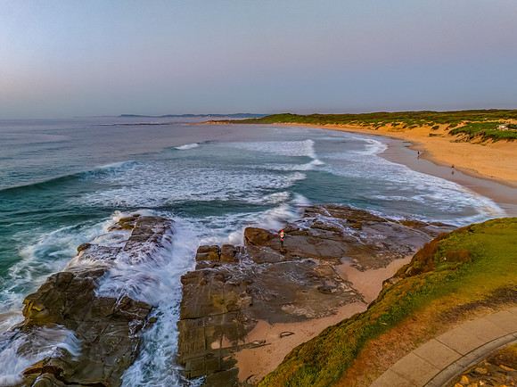 Sunrise over the sea and rocks with clear skies