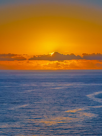 Sunrise over the sea and rocks with clear skies