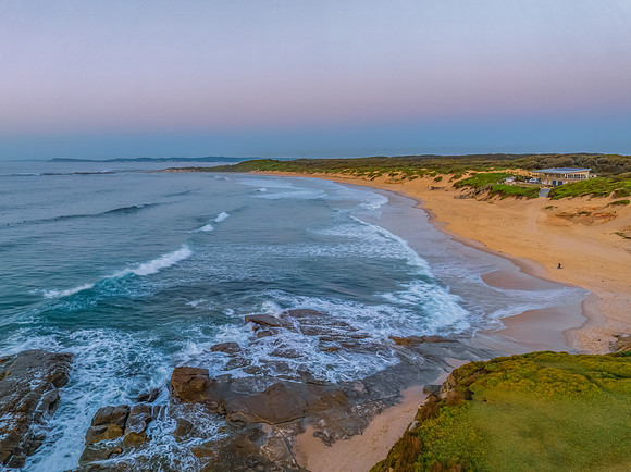 Sunrise over the sea and rocks with clear skies