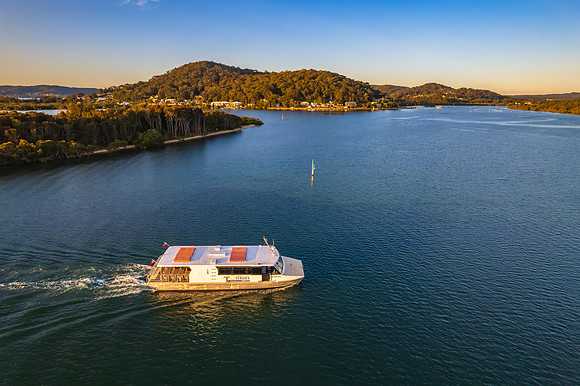 Late afternoon aerial waterscape over the bay with ferry