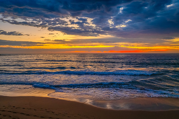 Pretty Sunrise at the seaside with rain clouds