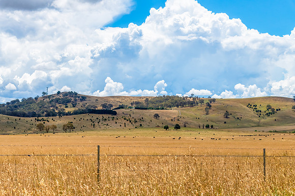 Countryside and storm clouds with blue sky