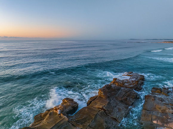 Sunrise over the sea and rocks with clear skies