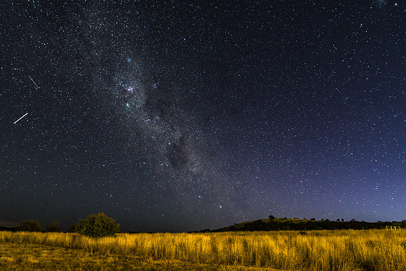 The night sky and Milky Way Galaxy with satellites