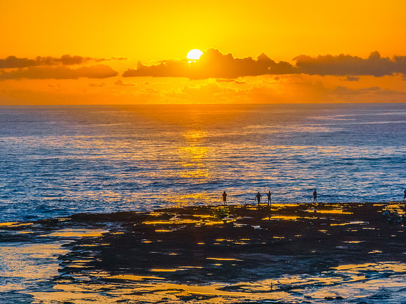 Sunrise over the sea and rocks with clear skies