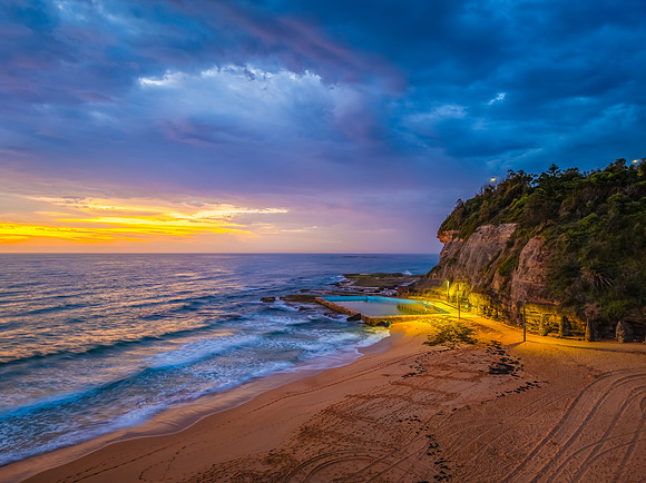 Pretty Sunrise at the seaside with rain clouds