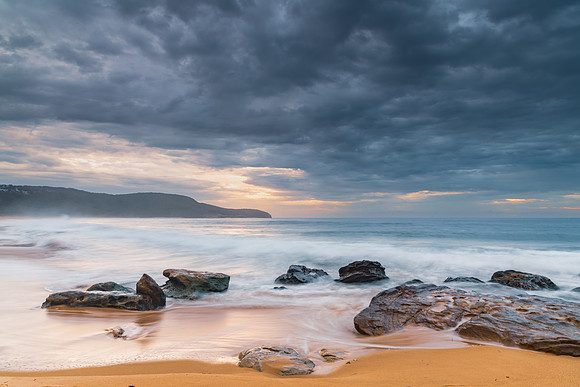 Sunrise at the seaside with rocks and beautiful diffused light b