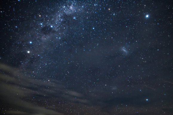 Stargazing at the night sky and milky way with clouds