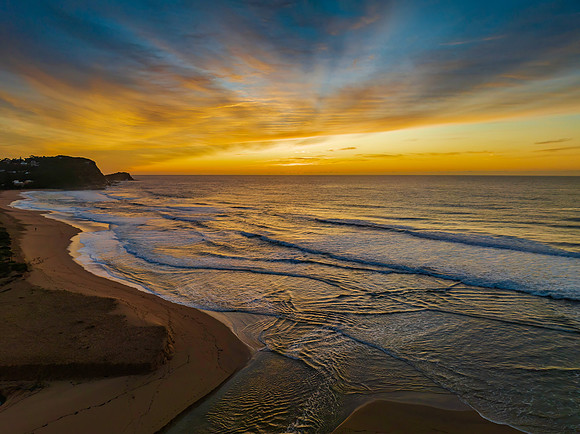 Sunrise and high cloud cover by the sea and lagoon