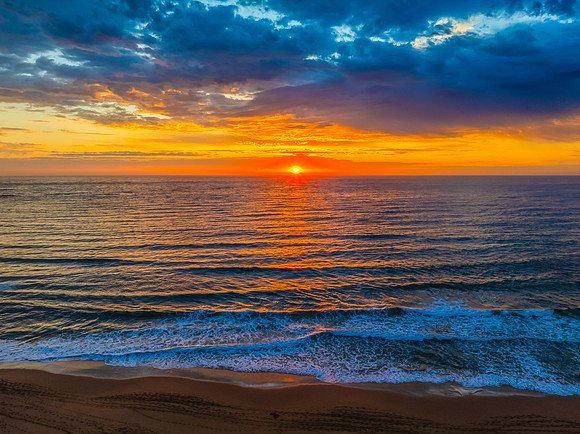 Pretty Sunrise at the seaside with rain clouds