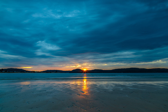 Colourful cloud filled sunrise at the seaside