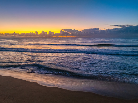 Sunrise over the sea with a low cloud bank and fog