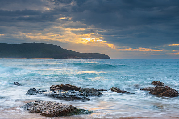 Sunrise at the seaside with rocks and beautiful diffused light b