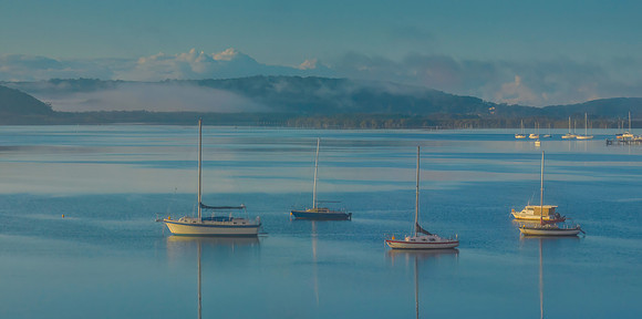 Boats and fog drifting over the bay