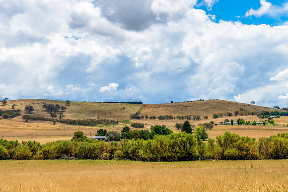 Countryside and storm clouds with blue sky