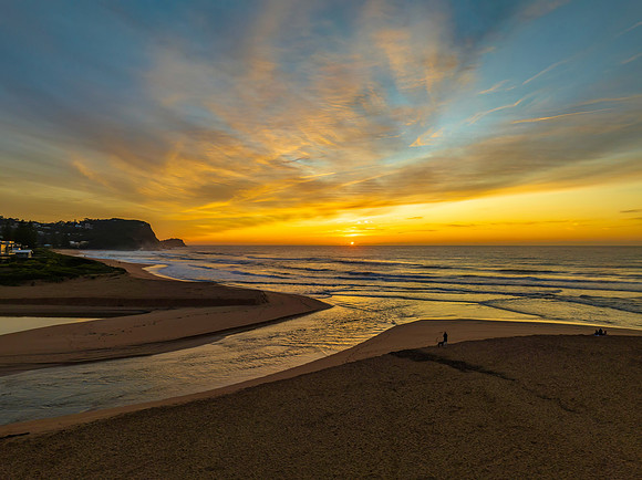 Sunrise and high cloud cover by the sea and lagoon