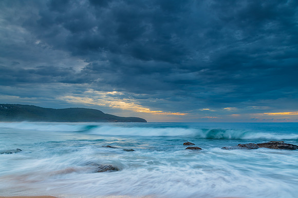 Sunrise at the seaside with rocks and beautiful diffused light b