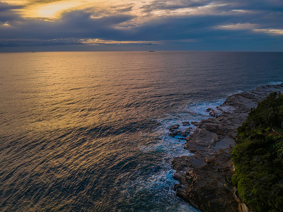 Aerial sunrise at the seaside in shades of blue and grey