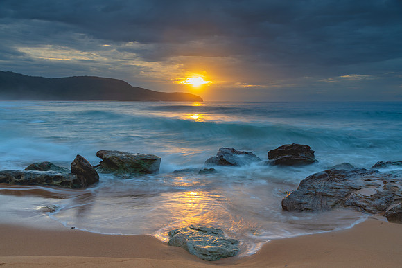Sunrise at the seaside with rocks