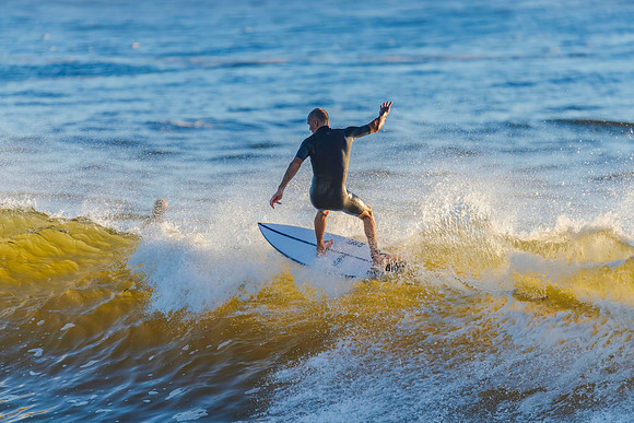 Early morning surfer and waves at the seaside
