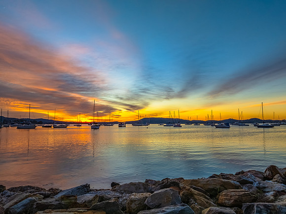 Aerial sunrise waterscape with boats and high cloud