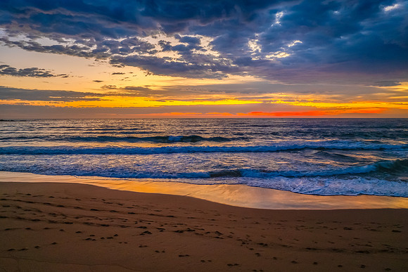 Pretty Sunrise at the seaside with rain clouds