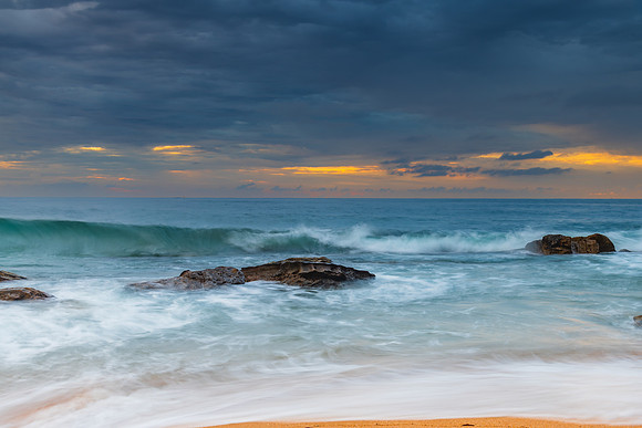 Sunrise at the seaside with rocks and beautiful diffused light b