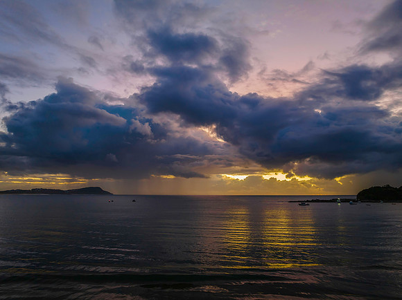 Aerial sunrise at the seaside with rain clouds