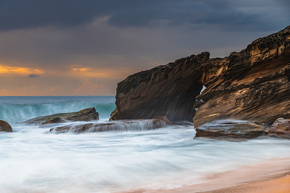 Sunrise at the seaside with rocks and beautiful diffused light b