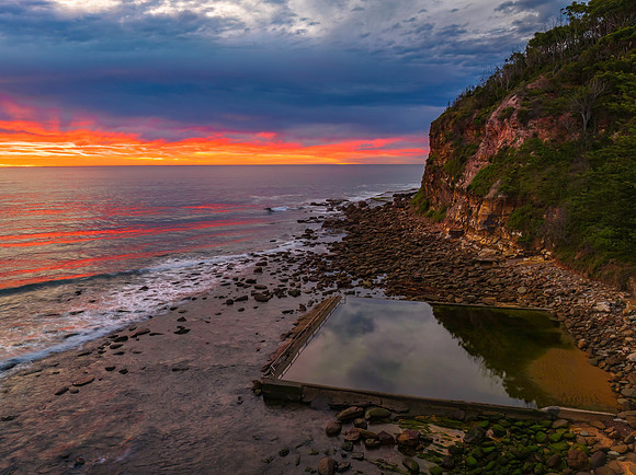 Cloud filled sunrise seascape and sea pool