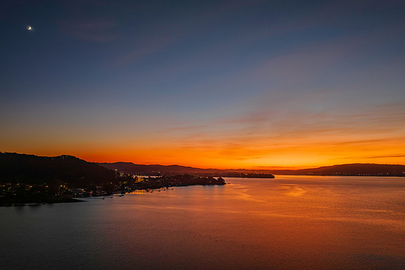 Aerial sunrise waterscape with boats and high cloud