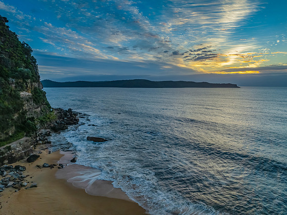 Sunrise, clouds and surf at the seaside