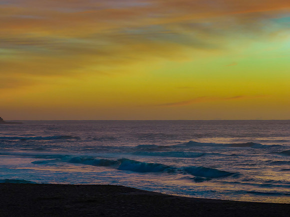 Sunrise and high cloud cover by the sea and lagoon