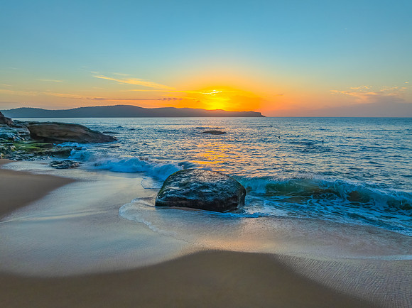 Aerial sunrise at the seaside with light scattered high cloud an