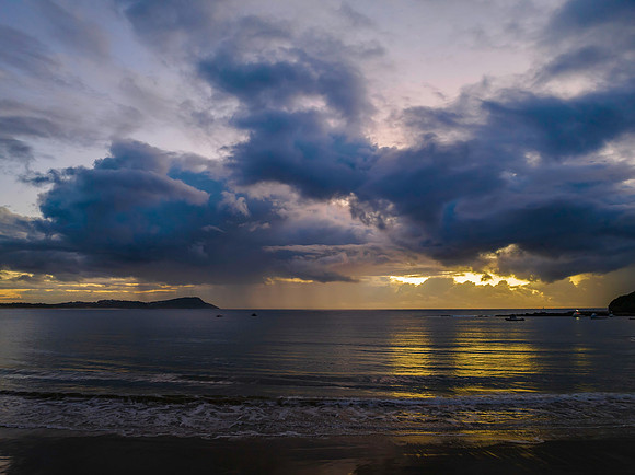 Aerial sunrise at the seaside with rain clouds