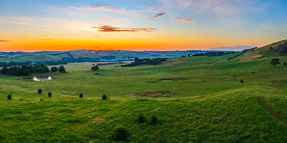 Sunrise panorama over rural land with high cloud