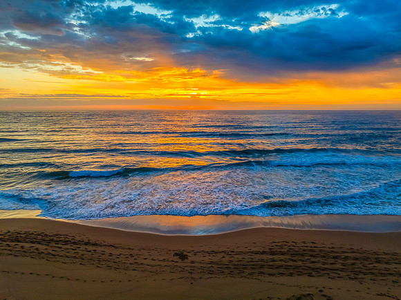 Pretty Sunrise at the seaside with rain clouds