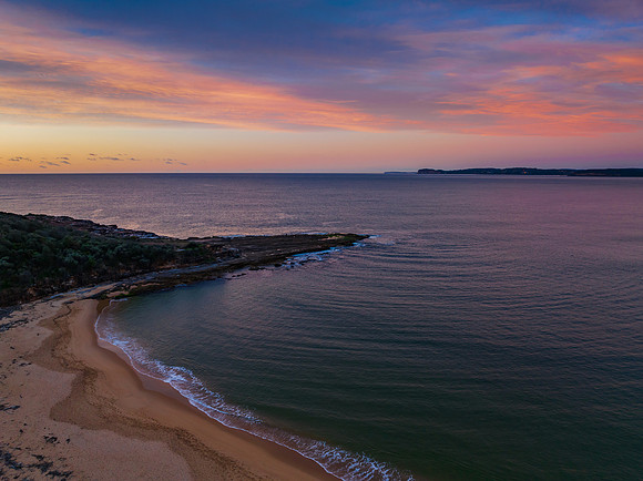 High cloud sunrise over the beach and mountain