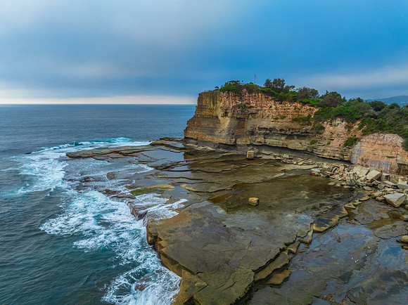 Sunrise seascape and rocky Inlet with thick fog cloud
