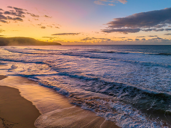 Aerial sunrise at the beach with clouds