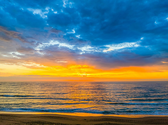 Pretty Sunrise at the seaside with rain clouds