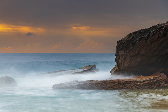 Sunrise at the seaside with rocks and beautiful diffused light b