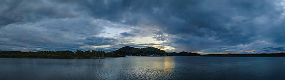 Rain clouds sunrise panorama over the bay
