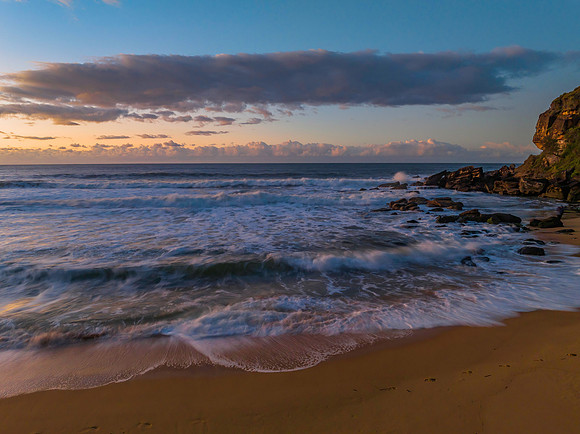 Aerial sunrise at the beach with clouds