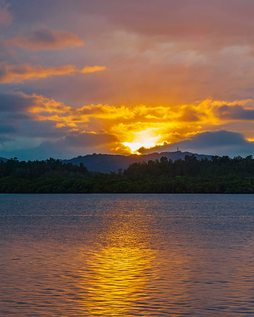 The sun trying to burst through the rain clouds and shine over t