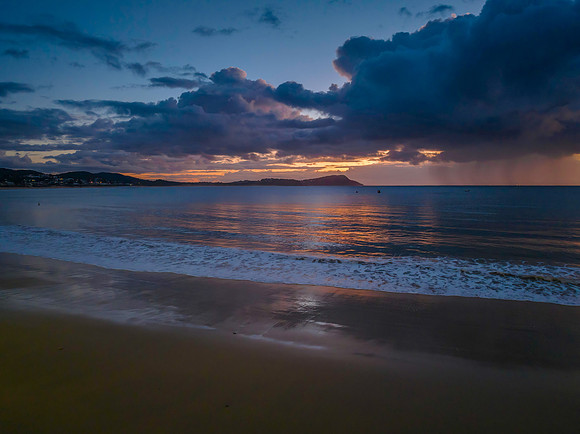 Aerial sunrise at the seaside with rain clouds