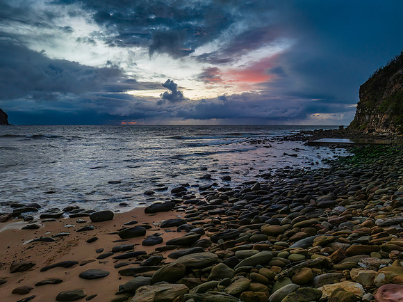 Moody sunrise seascape with rain clouds