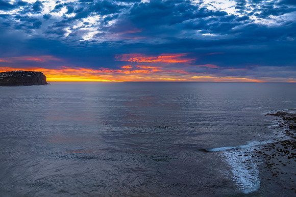 Cloud filled sunrise seascape
